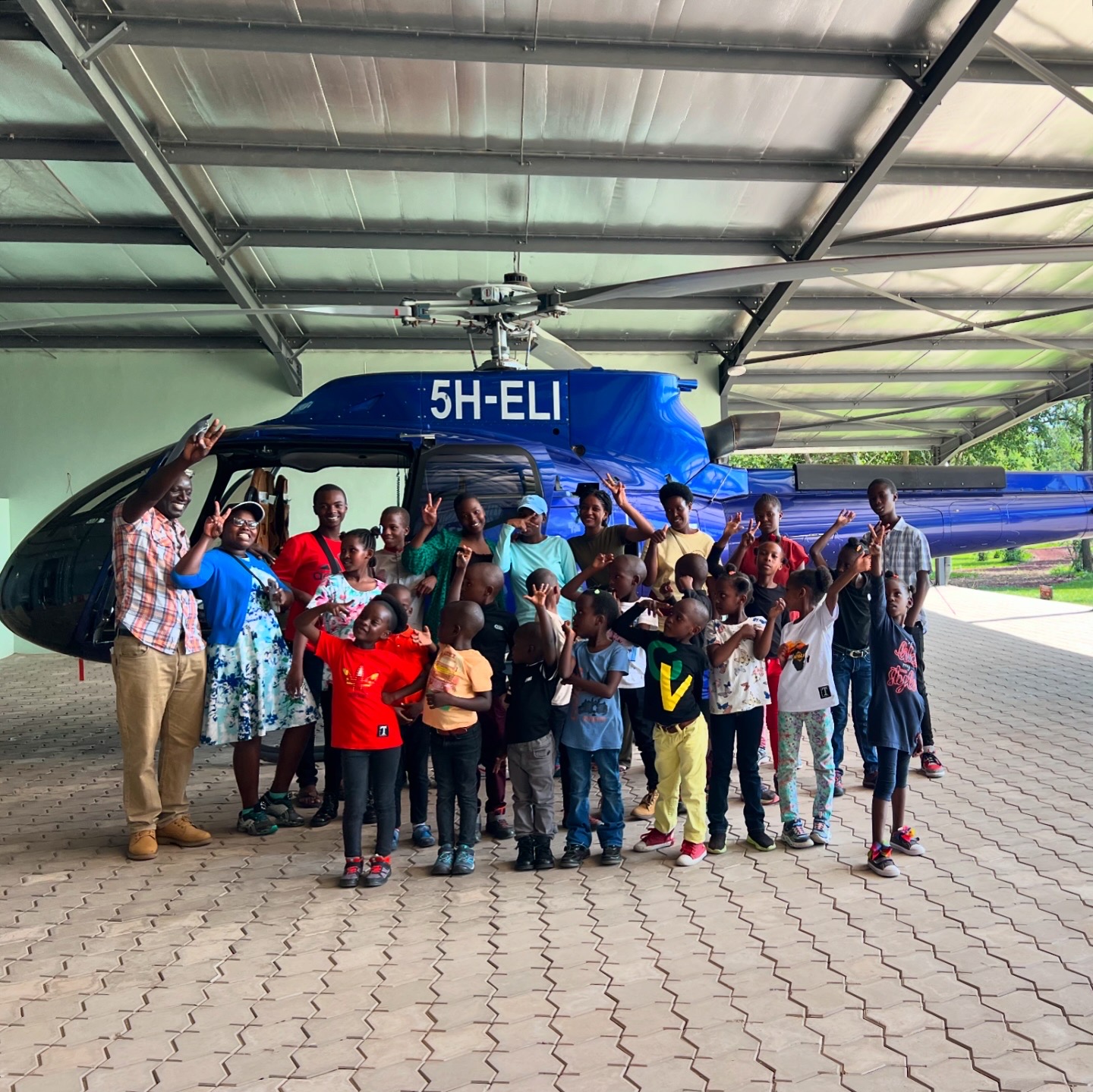 Children from local orphanage exploring Tropic Helicopters' Tango Tango Zulu hangar in Arusha.